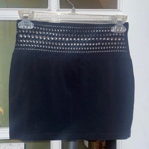 Black mini skirt with silver stud accents.